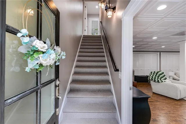 a view of entryway and hall with wooden floor