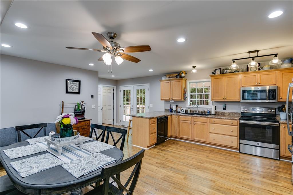 1800 Mandeville Road Bremen, GA 30110 - Photo 18 of 41 a kitchen with stainless steel appliances wooden floor dining table and chairs