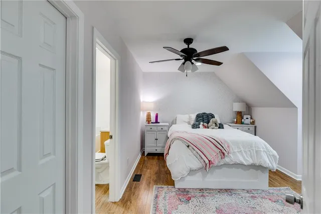a bed room with a bed and a ceiling fan