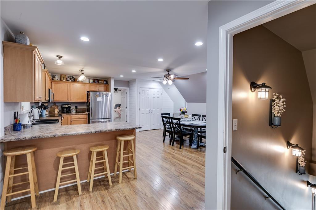 1800 Mandeville Road Bremen, GA 30110 - Photo 28 of 41 a kitchen with stainless steel appliances kitchen island granite countertop a table chairs sink and cabinets