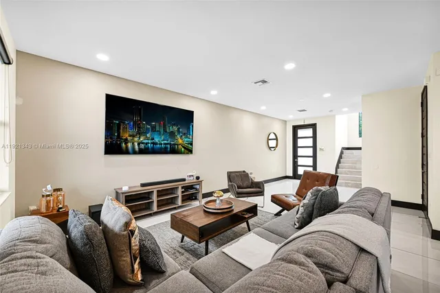 a kitchen with stainless steel appliances granite countertop a sink a stove a microwave and refrigerator