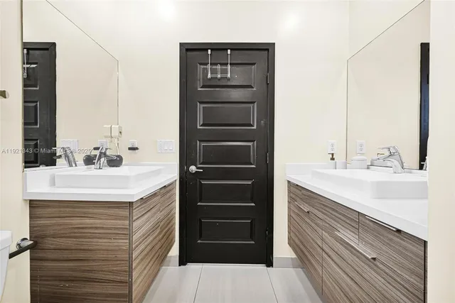 a living room with furniture a flat screen tv and a window