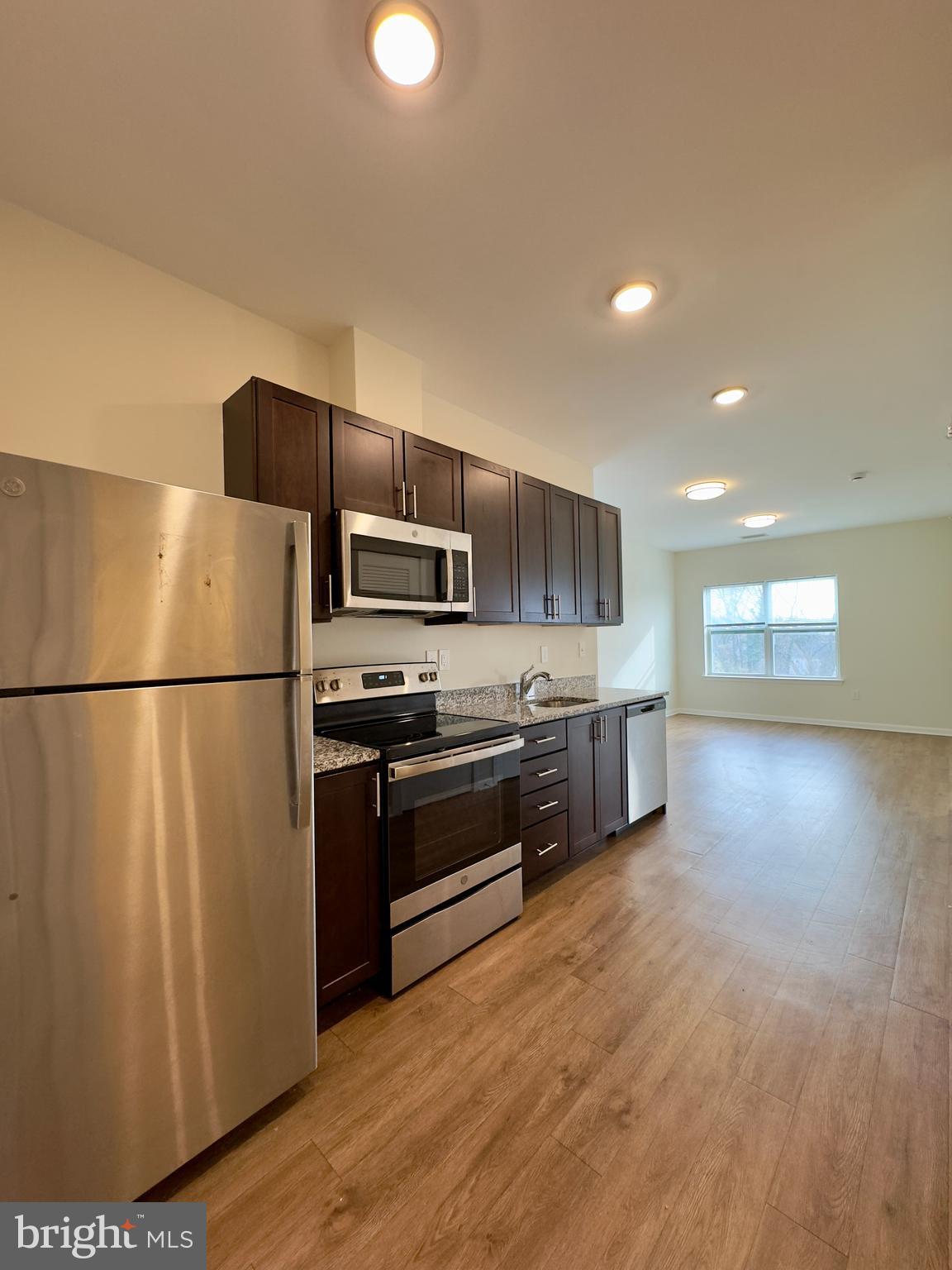 4909 Hamilton Avenue, Unit 4909B Baltimore, MD 21206 - Photo 11 of 15 a kitchen with stainless steel appliances a refrigerator a stove a microwave and a refrigerator