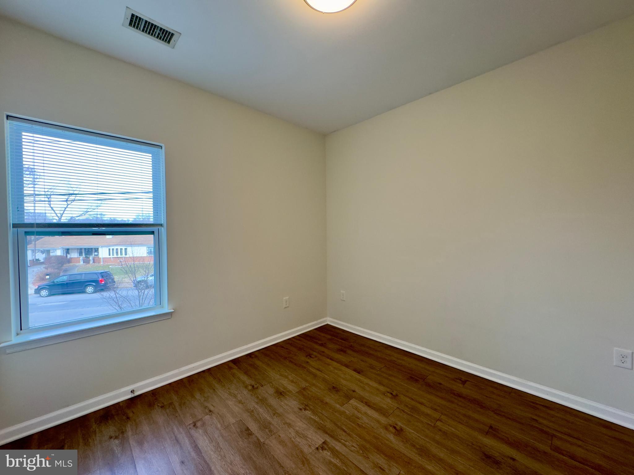 4909 Hamilton Avenue, Unit 4909B Baltimore, MD 21206 - Photo 13 of 15 a view of a small space with wooden floor and a window