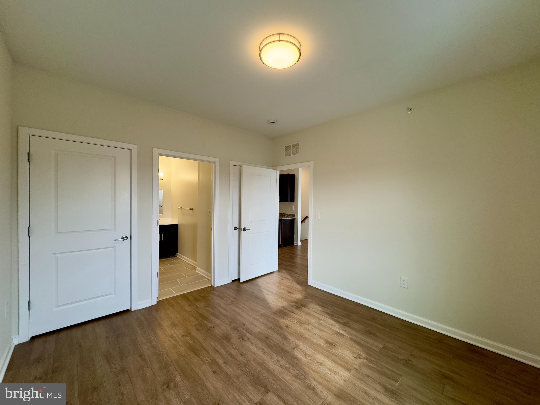 4909 Hamilton Avenue, Unit 4909B Baltimore, MD 21206 - Photo 5 of 15 a view of empty room with wooden floor