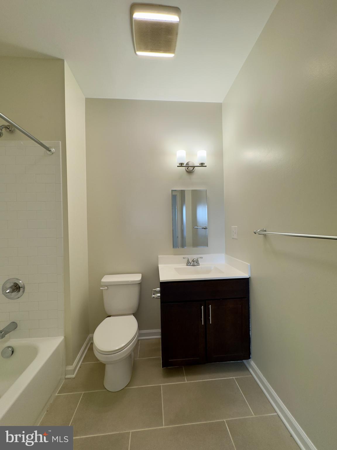 4909 Hamilton Avenue, Unit 4909B Baltimore, MD 21206 - Photo 6 of 15 a bathroom with a sink a toilet and shower