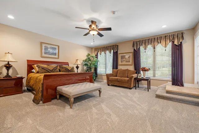a bathroom with a granite countertop sink mirror and toilet