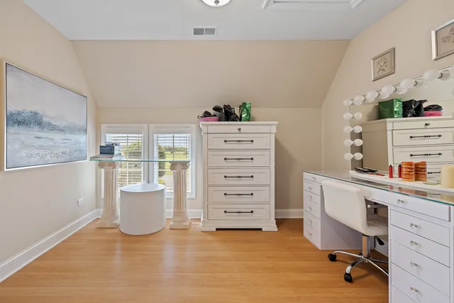 a bedroom with a bed mirror and window
