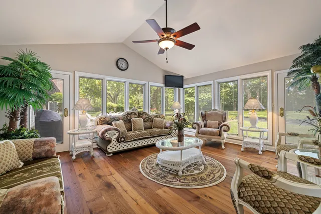 a living room with furniture and a wooden floor