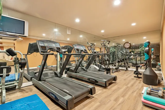 a bathroom with a granite countertop toilet a sink and a mirror