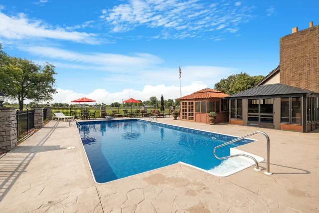 a view of a patio with couches table and chairs and potted plants