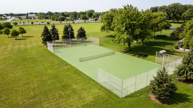 a front view of a house with a garden and yard
