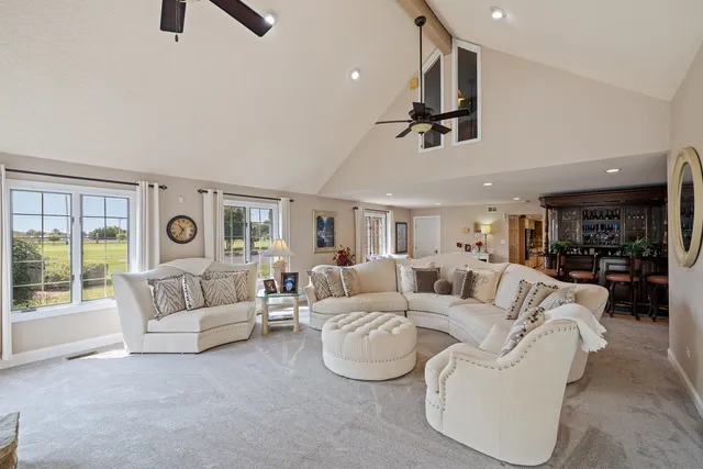 a living room with furniture a table and chairs