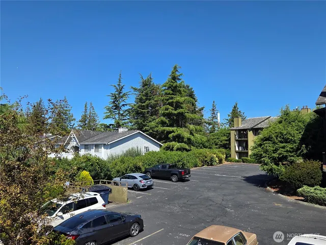 a view of a street with some trees in the background