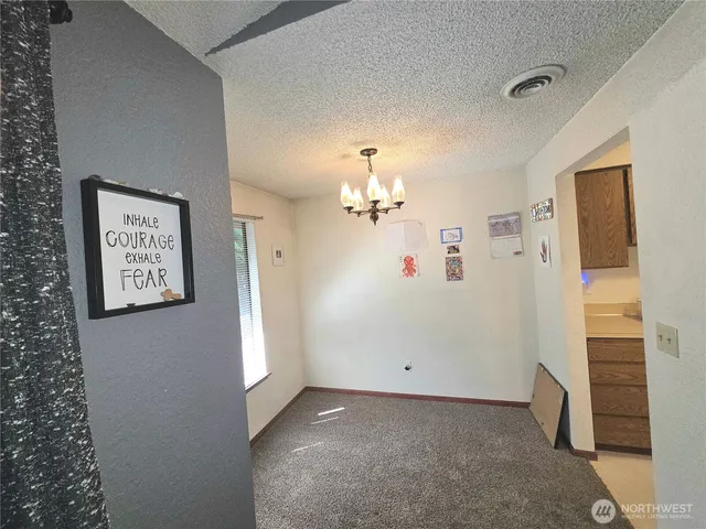 a view of a hallway with chandelier