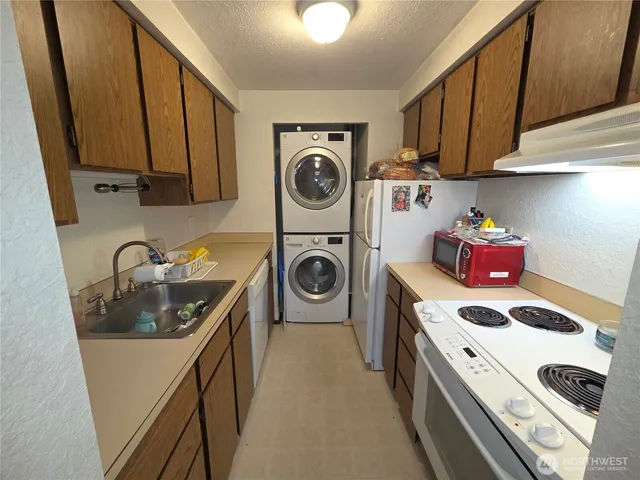 a utility room with sink dryer and washer