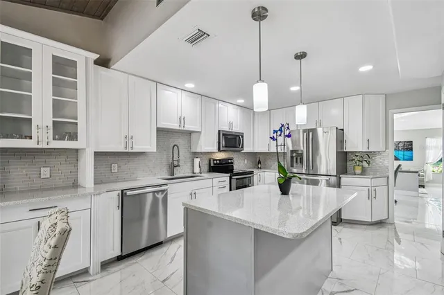 a living room with furniture a flat screen tv and a large window