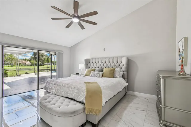 a bathroom with a granite countertop double vanity and a mirror