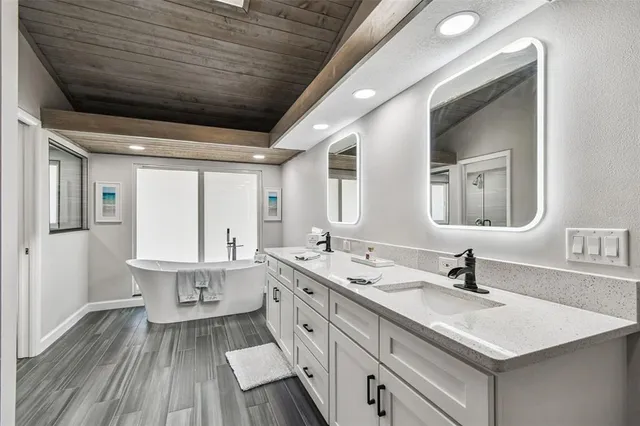 a bathroom with a sink vanity mirror and toilet