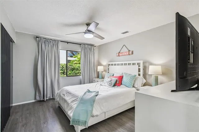 a front view of a house with a yard and potted plants
