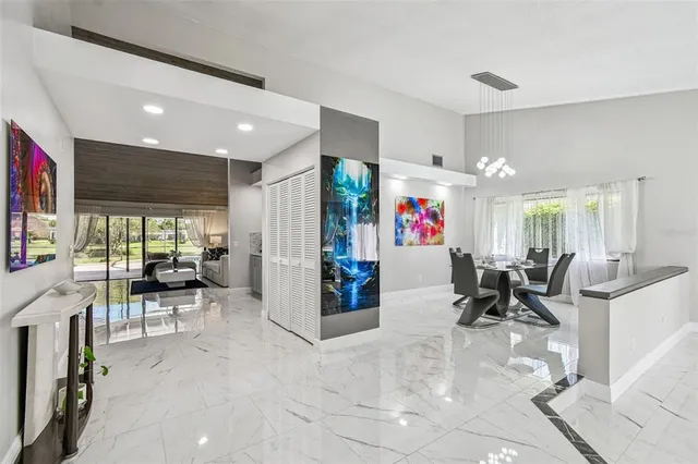 a view of a dining room with furniture and a chandelier