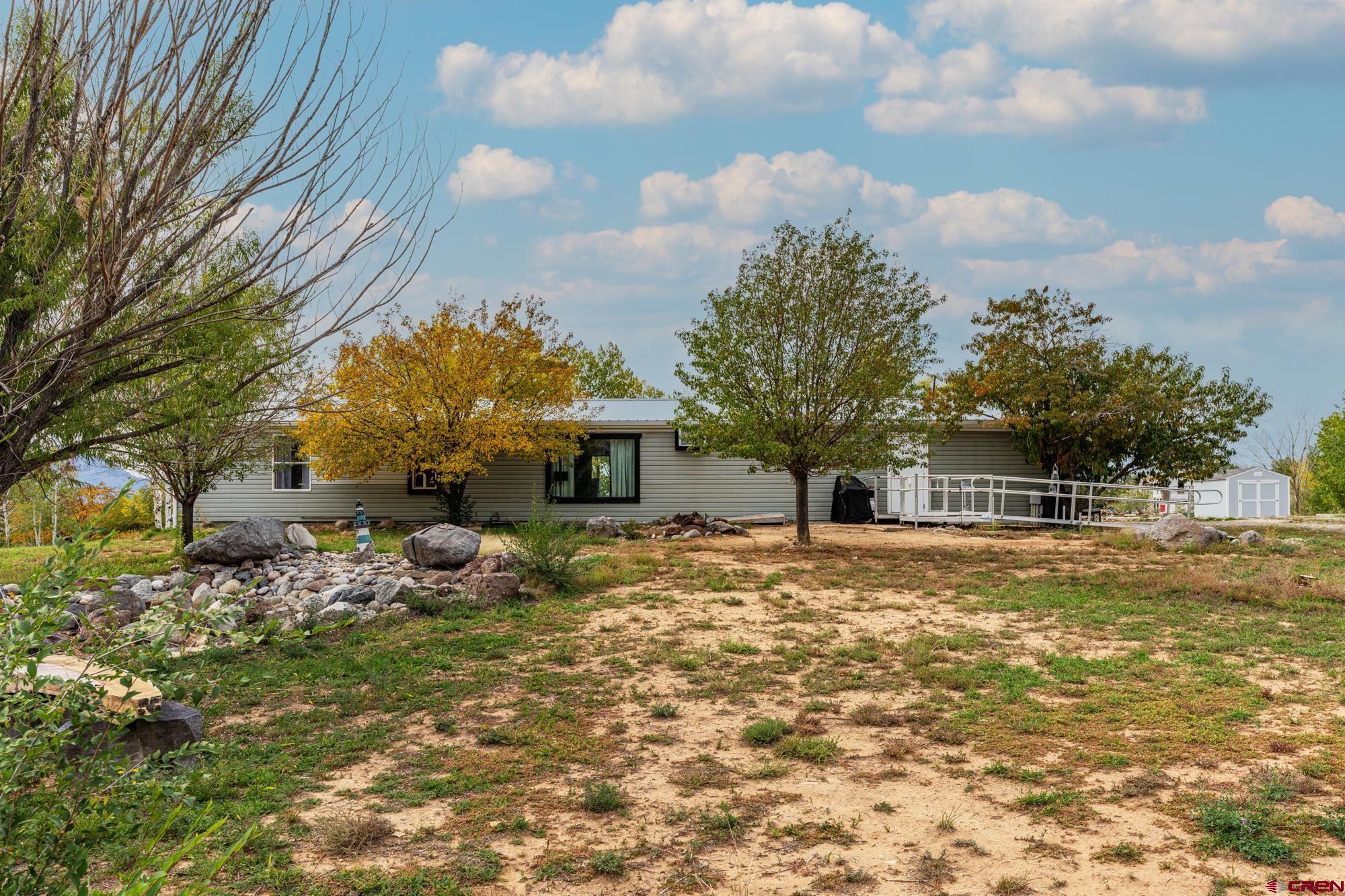 25109 Rd L.4 Cortez, CO 81321 - Photo 22 of 33 a front view of a house with a yard and garage
