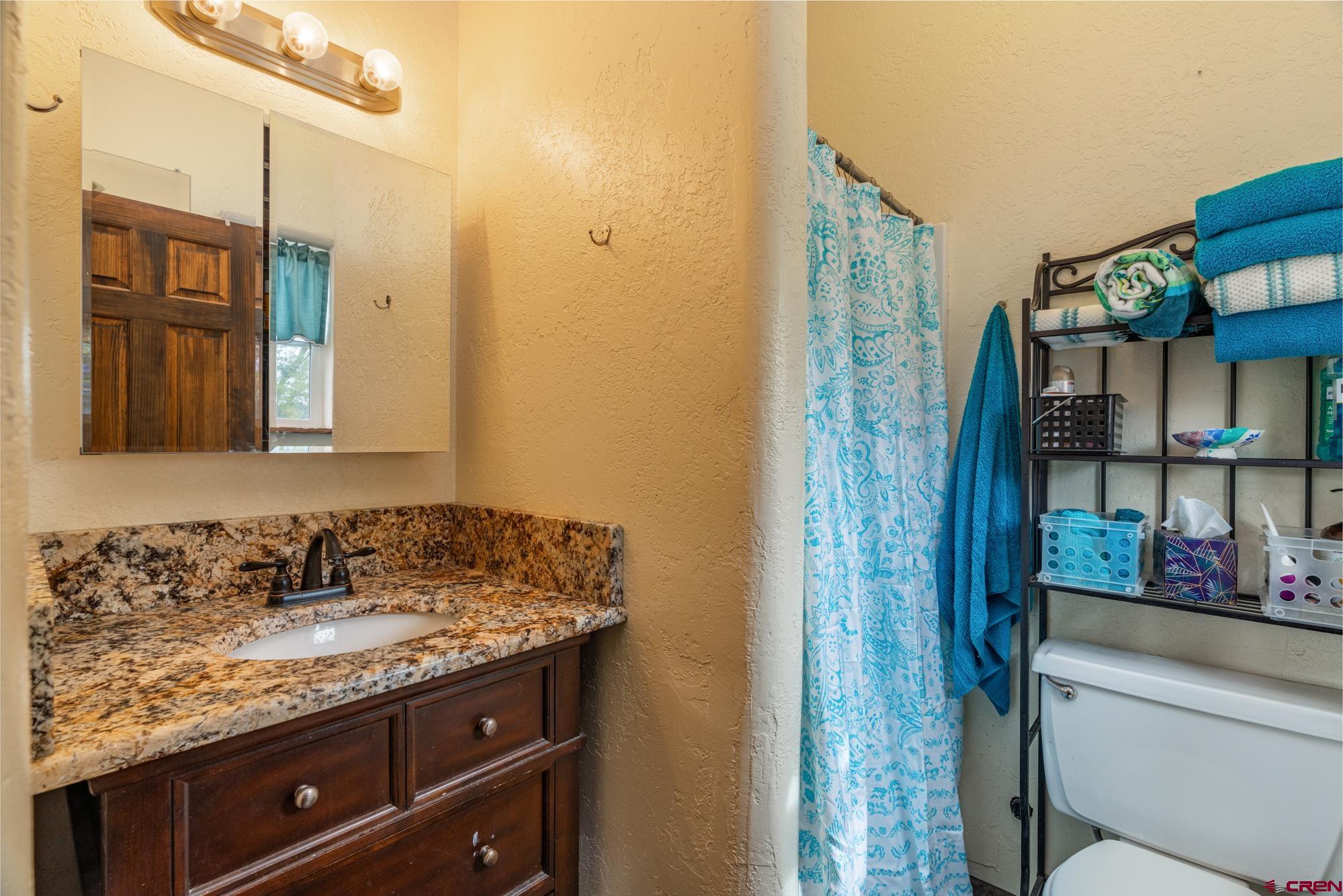 25109 Rd L.4 Cortez, CO 81321 - Photo 30 of 33 a bathroom with a granite countertop sink and a mirror