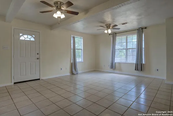 a view of an empty room with a window