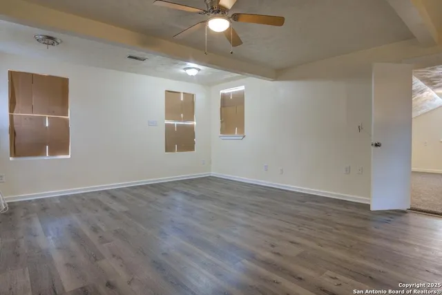 wooden floor in an empty room with a window