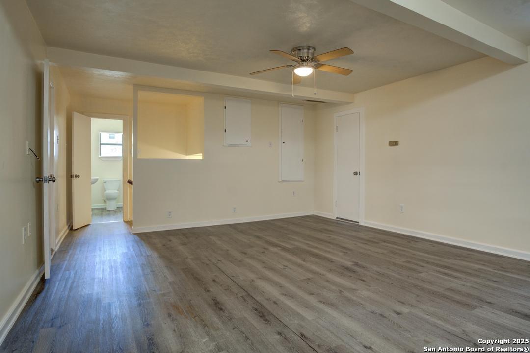 1176 Old Adams Lane Pleasanton, TX 78064 - Photo 21 of 42 wooden floor in an empty room with a window