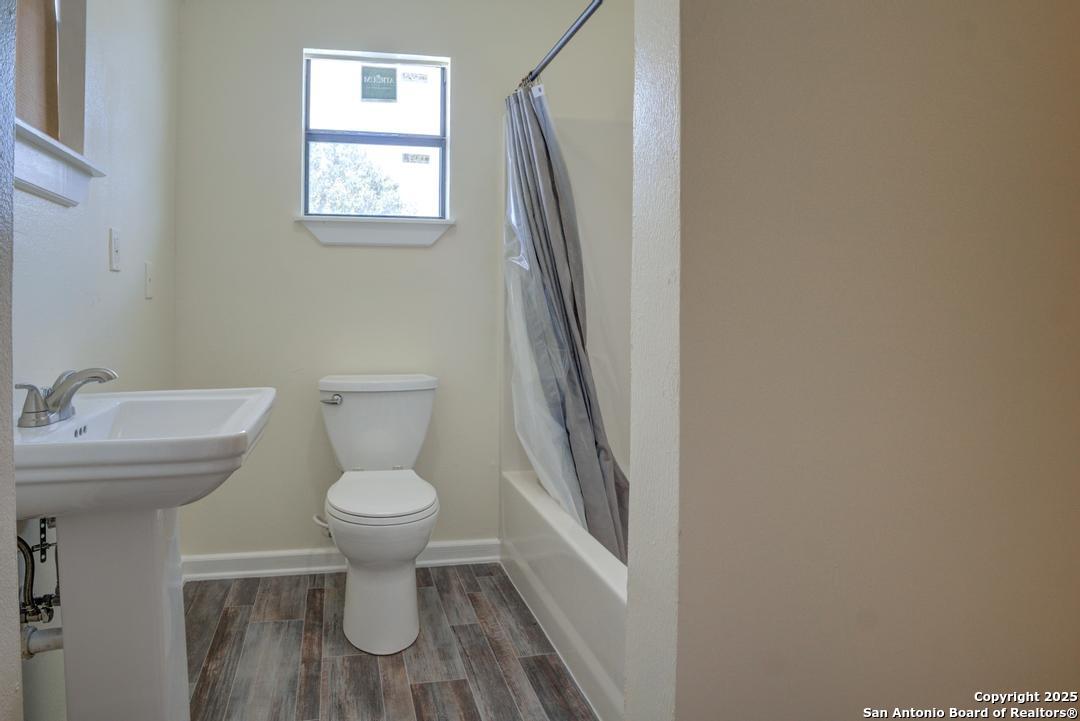 1176 Old Adams Lane Pleasanton, TX 78064 - Photo 22 of 42 a bathroom with a sink toilet and a mirror
