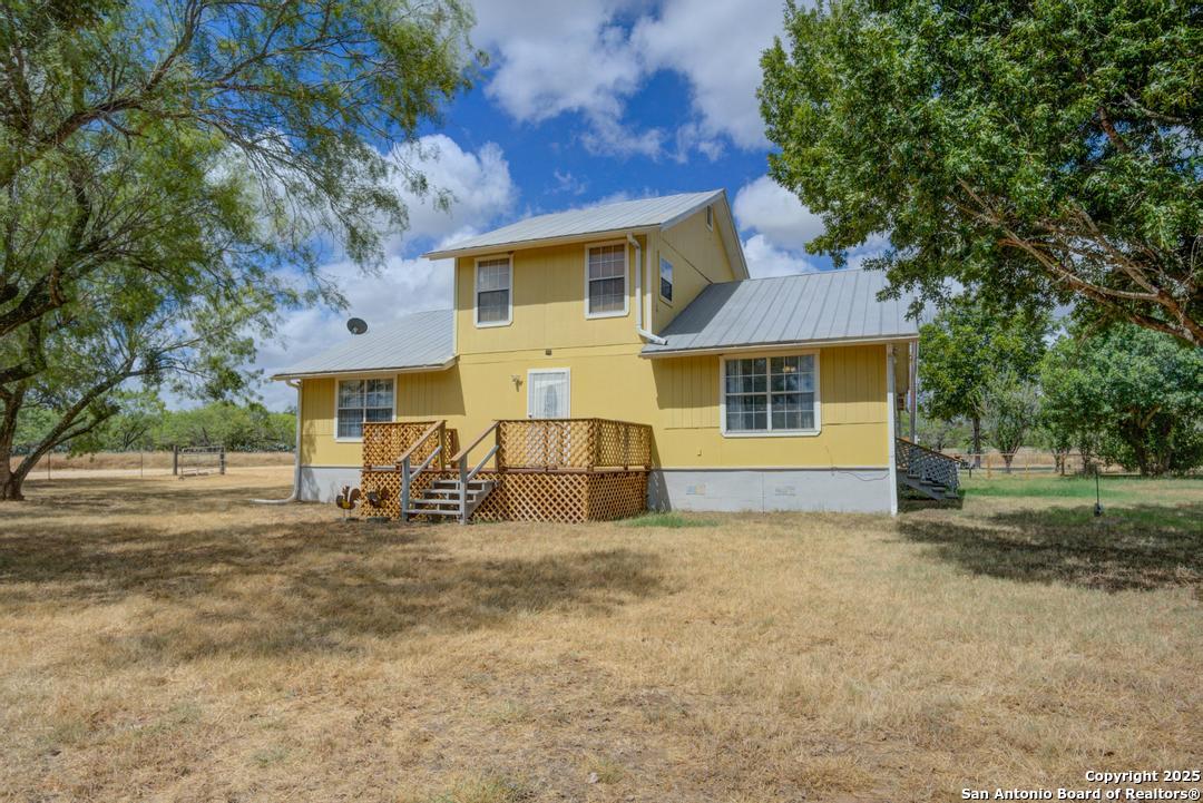 1176 Old Adams Lane Pleasanton, TX 78064 - Photo 3 of 42 a front view of a house with a yard