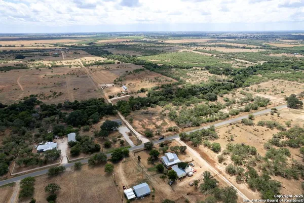 an aerial view of residential houses with outdoor space