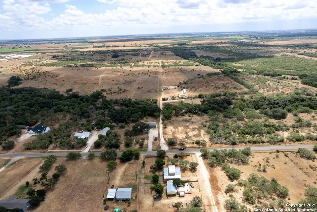 an aerial view of residential houses with outdoor space