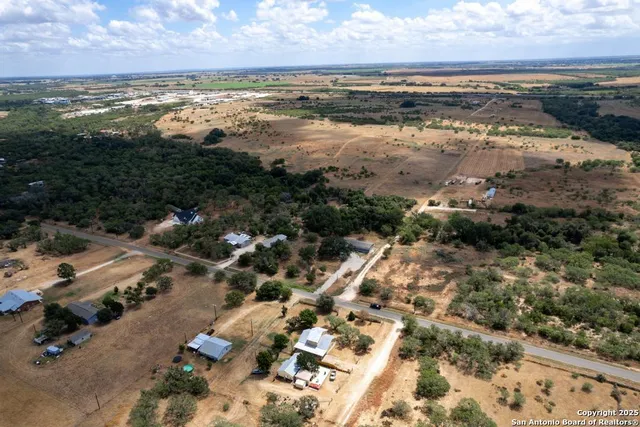 an aerial view of residential houses with outdoor space