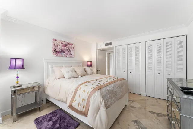 a spacious bedroom with a bed and a window