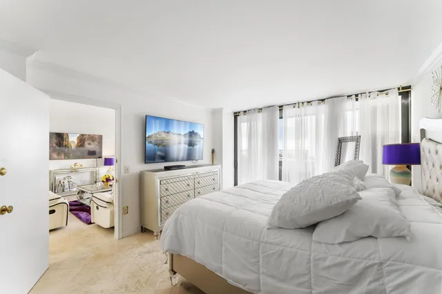 a bedroom with a bed and a flat screen tv