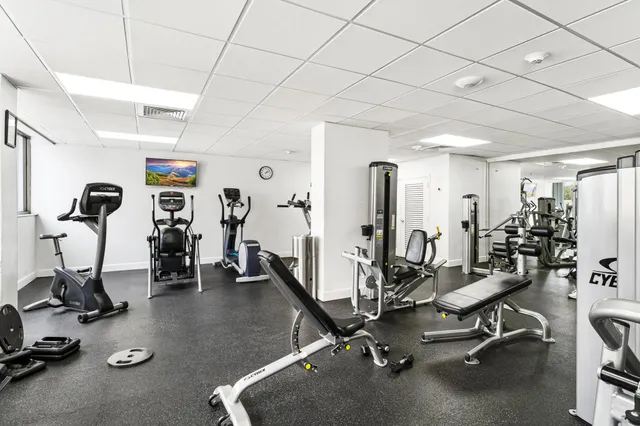 a room with pool table and windows