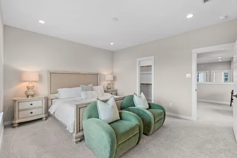 a spacious bedroom with a bed and a couch