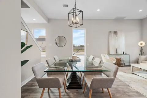 a dining room with furniture and window