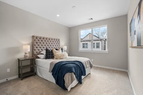 a bedroom with a bed and a lamp