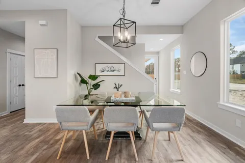 a view of a dining room with furniture and wooden floor