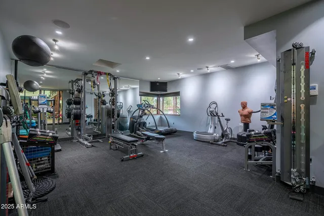 a bedroom with bed and a mirror