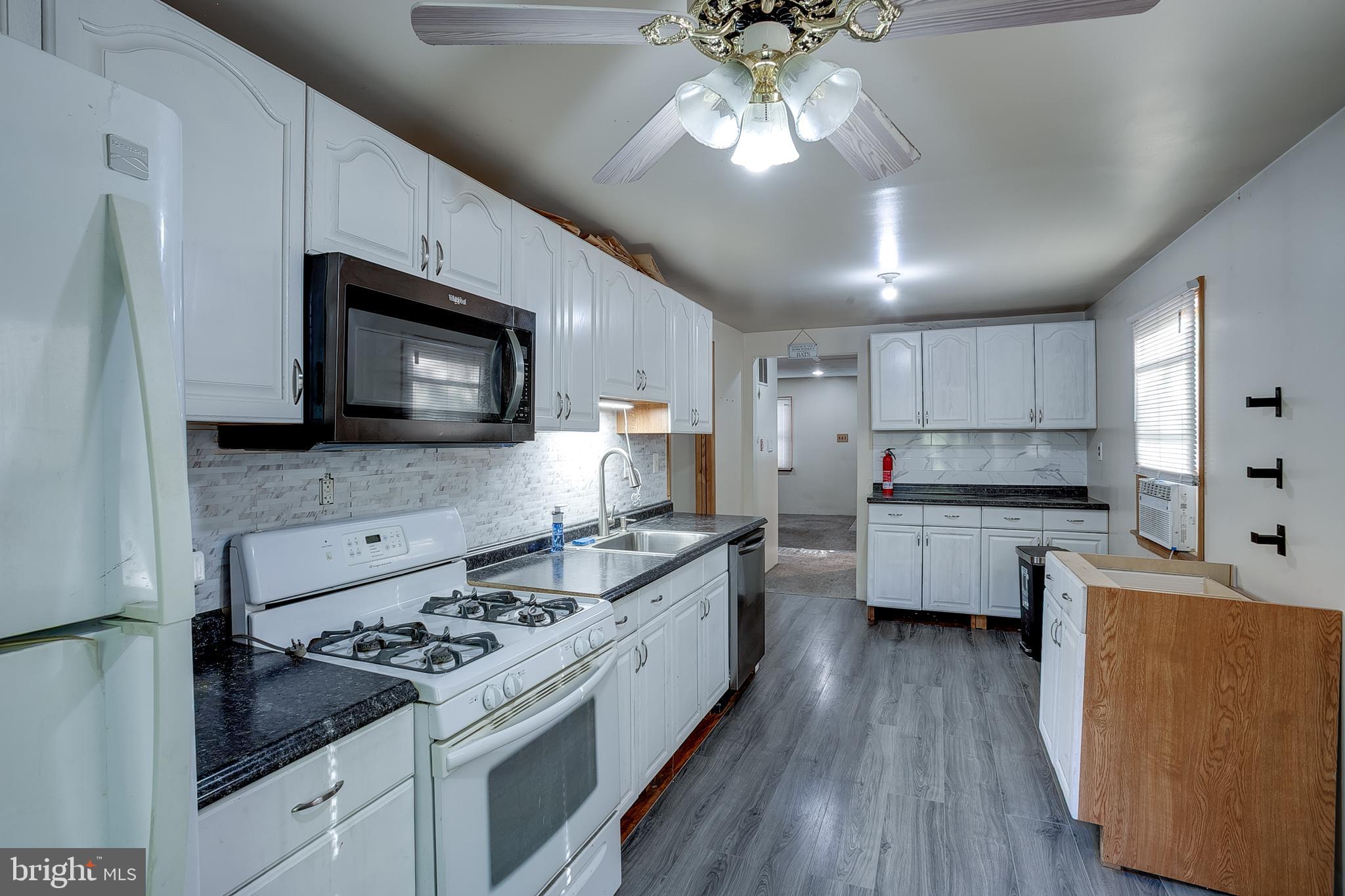 111 Carson Road Southampton, NJ 08088 - Photo 6 of 14 a kitchen with stainless steel appliances a stove sink microwave and cabinets