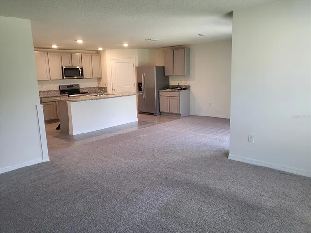 a kitchen with refrigerator and microwave