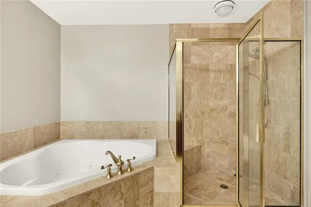 a bathroom with a bathtub and shower