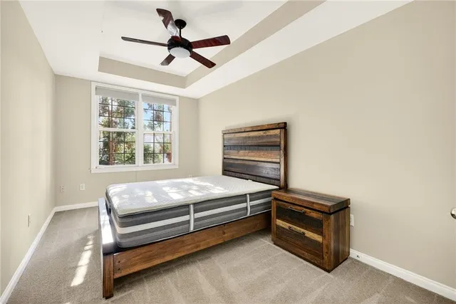 a bedroom with a bed and a ceiling fan