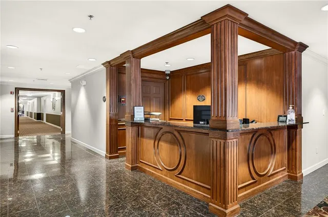 a living room with furniture fireplace and large windows