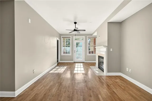 wooden floor in an empty room with a window