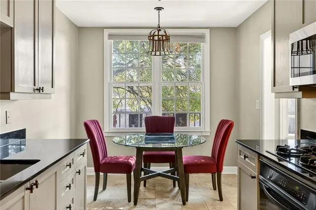 a dining room with furniture a chandelier and window